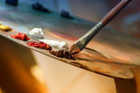 Palette with paint and paintbrush