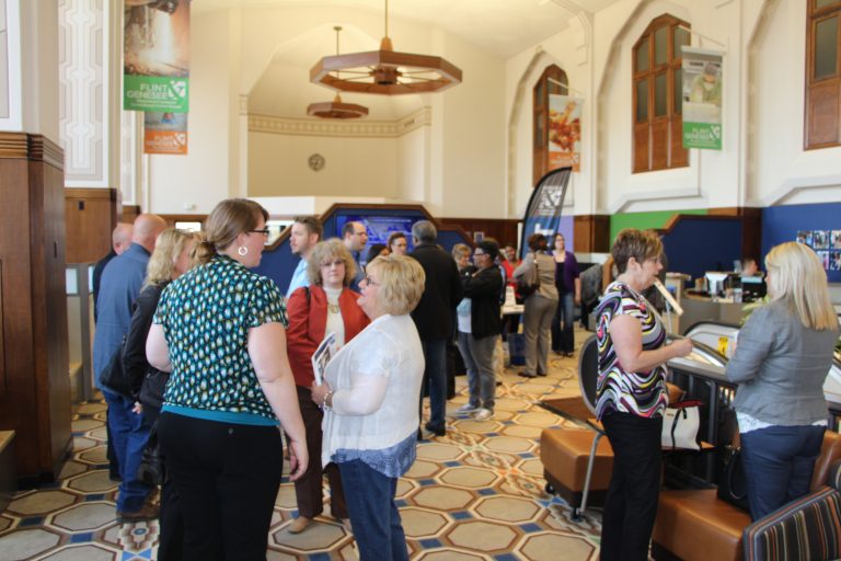 People enjoying coffee in the Flint and Genesee Chamber lobby