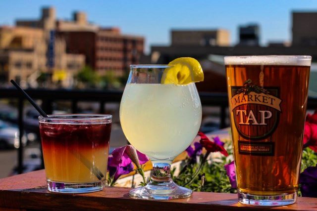 Image of three drinks in a line with a city skyline in the background. Click to go to Flint Farmers' Market webpage.